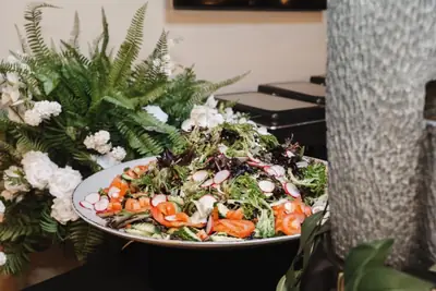 A large salad platter with greens and edible flowers