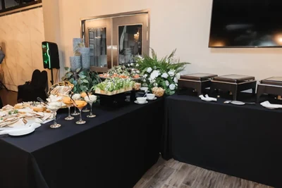 A buffet lit with candles, white florals and greenery