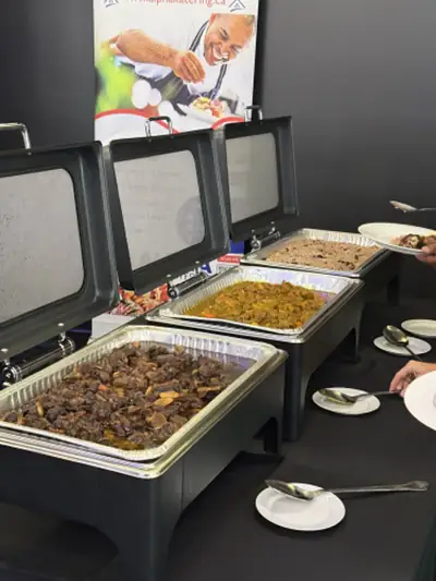 Rows of chafing dishes holding rice and stewed meat