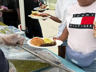 Alpha Katering servers plating hot food onto guests’ plates